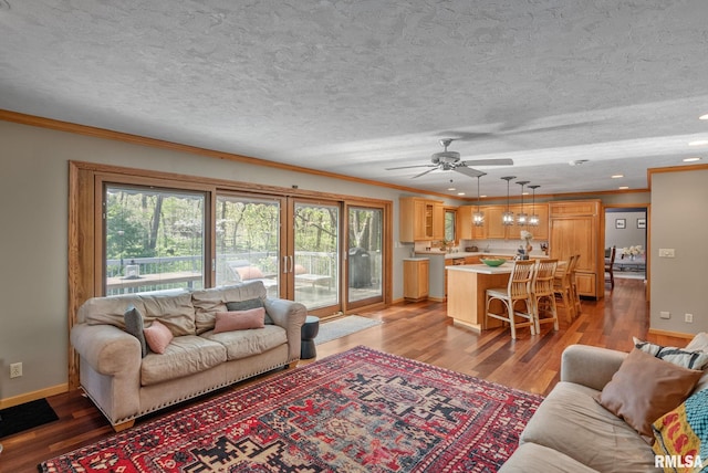 living area with crown molding, a textured ceiling, light wood-style flooring, and ceiling fan