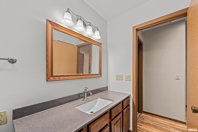 bathroom featuring vanity and wood finished floors