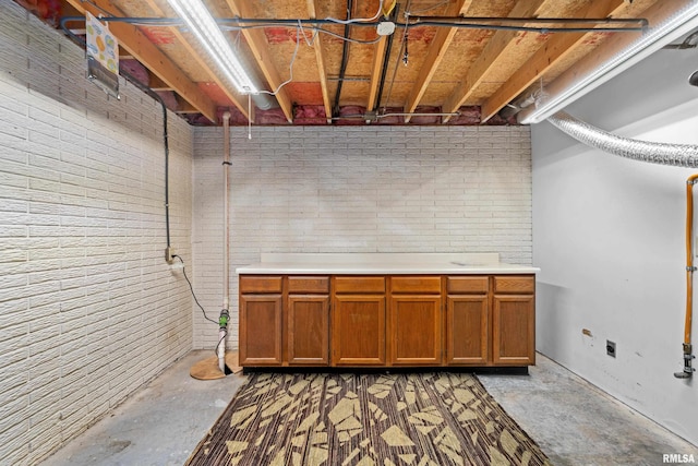 unfinished below grade area featuring brick wall