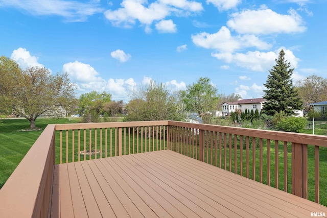 wooden terrace with a lawn