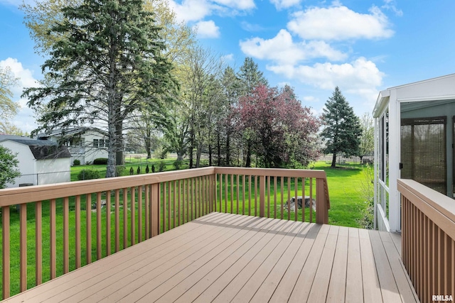wooden terrace featuring a yard