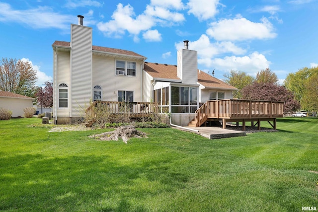 back of house with a lawn, a wooden deck, a chimney, and a sunroom