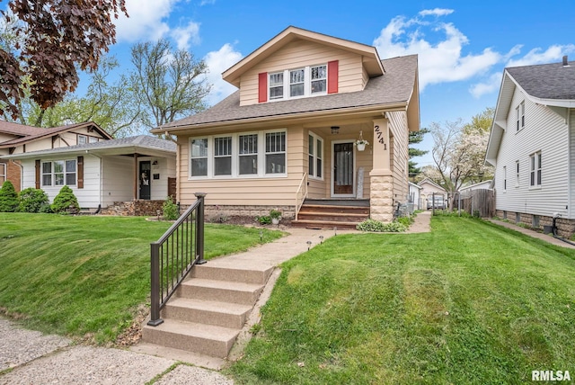 view of front of property with fence, a shingled roof, and a front lawn