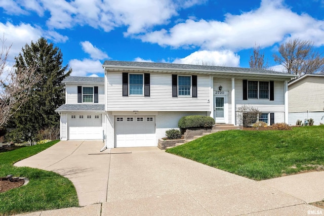 bi-level home featuring concrete driveway, brick siding, a front lawn, and a garage