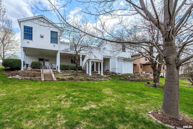 rear view of house featuring french doors and a yard