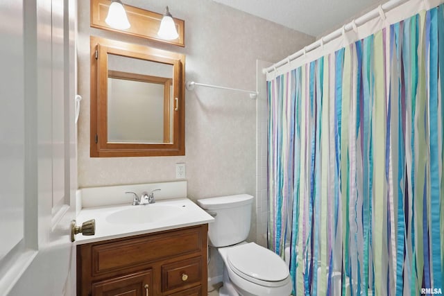 full bathroom with vanity, a shower with shower curtain, and toilet