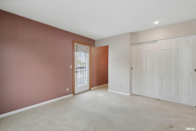 unfurnished bedroom featuring a closet, baseboards, carpet flooring, and recessed lighting