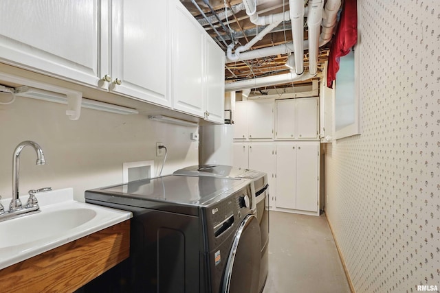 laundry room featuring cabinet space, separate washer and dryer, and a sink
