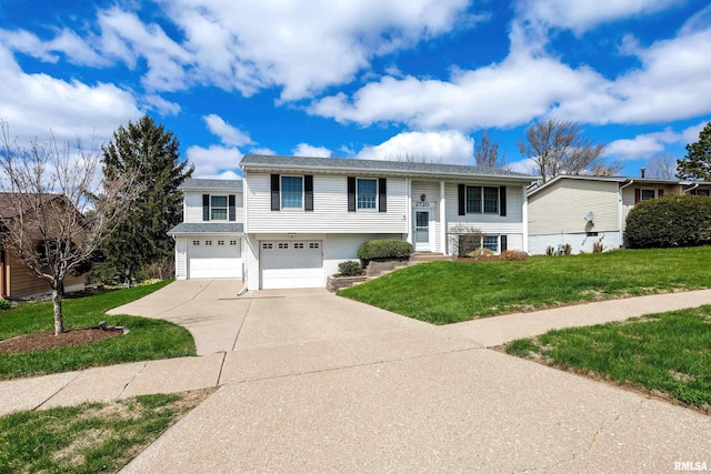 split foyer home featuring an attached garage, a front lawn, and driveway
