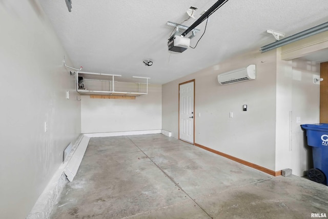 garage with baseboards, a garage door opener, and a wall mounted AC