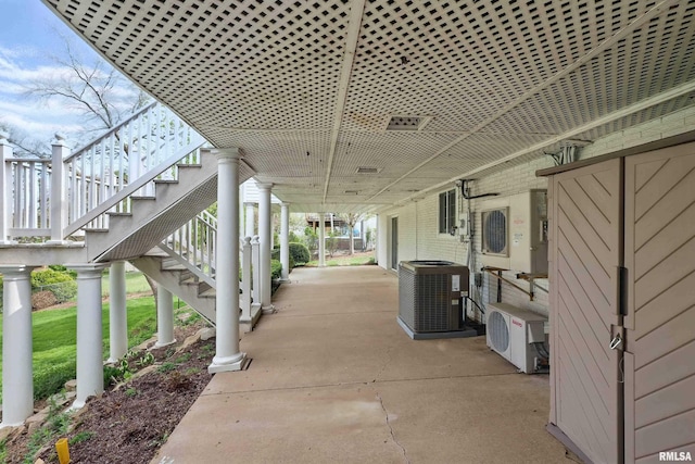 view of patio / terrace featuring stairs, ac unit, and central AC