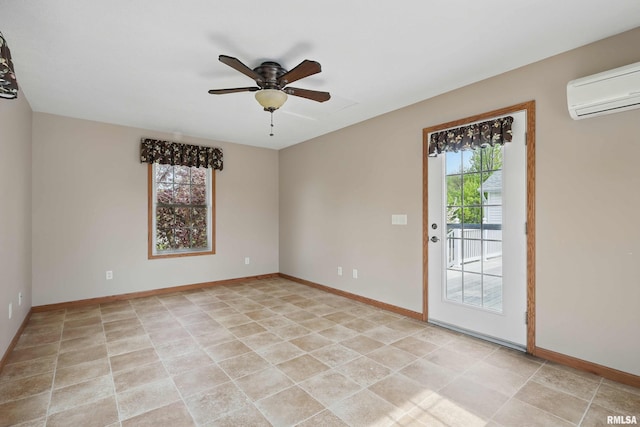 empty room featuring baseboards, a wall mounted air conditioner, ceiling fan, and light tile patterned floors