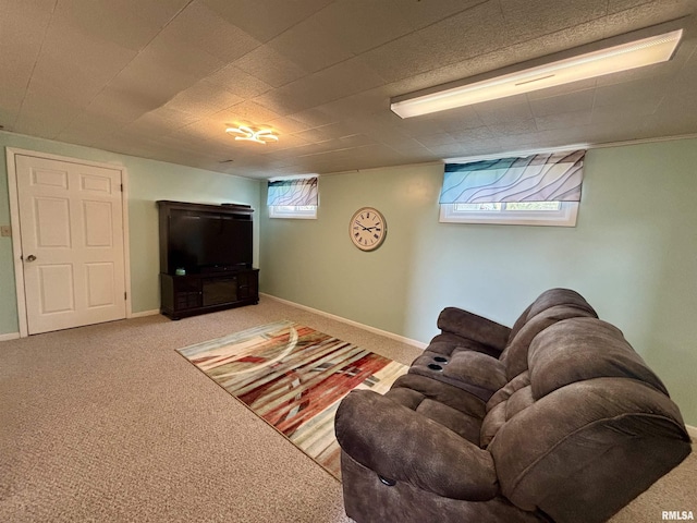 living area featuring carpet flooring and baseboards