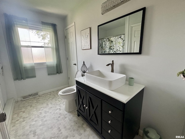 bathroom with toilet, visible vents, and vanity