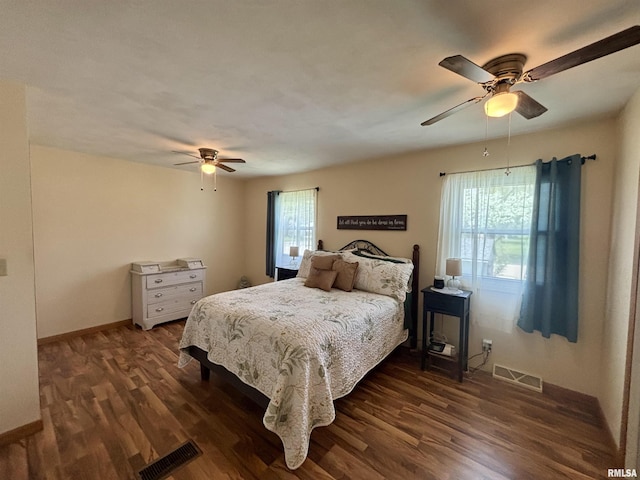 bedroom featuring visible vents, dark wood-style flooring, ceiling fan, and baseboards