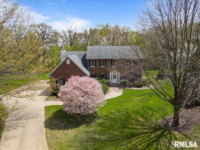 view of front of home featuring concrete driveway and brick siding