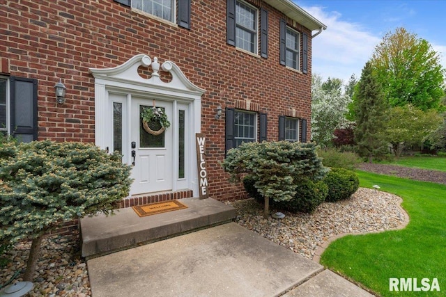 doorway to property featuring brick siding
