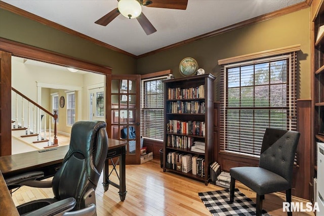 office area featuring a healthy amount of sunlight, crown molding, a ceiling fan, and light wood finished floors