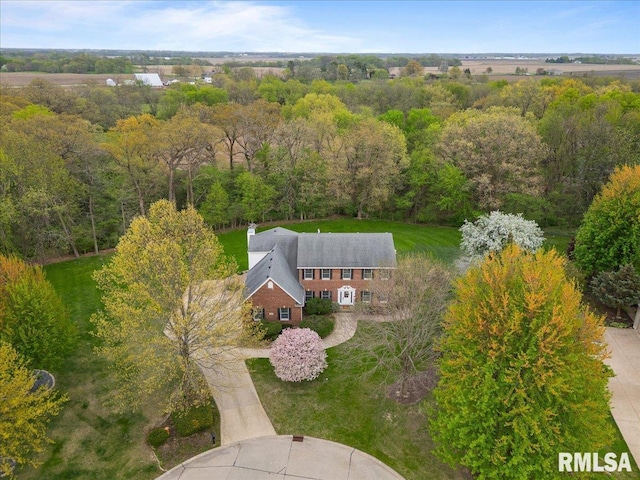 birds eye view of property with a wooded view