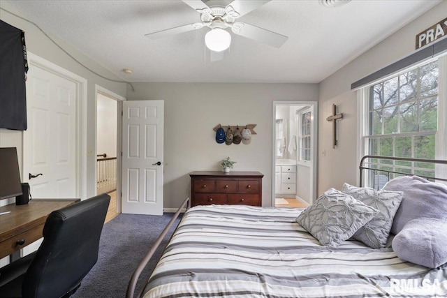 bedroom with baseboards, carpet flooring, connected bathroom, and a ceiling fan