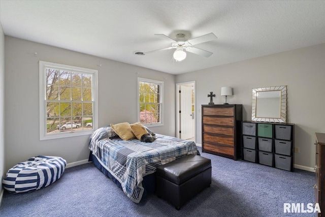 bedroom featuring baseboards, visible vents, ceiling fan, and carpet