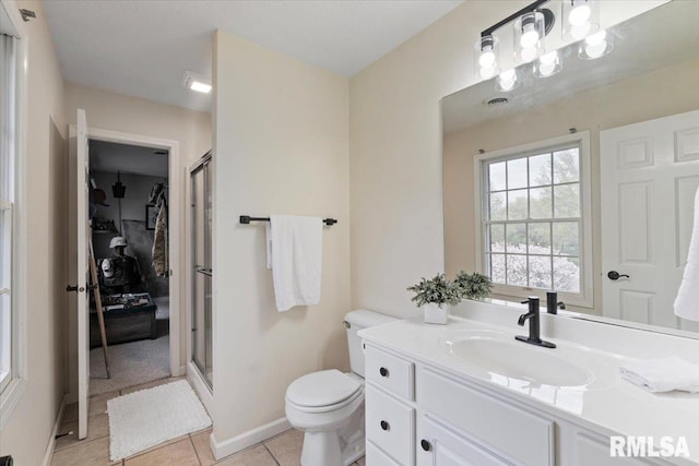 bathroom with tile patterned flooring, a stall shower, toilet, and vanity