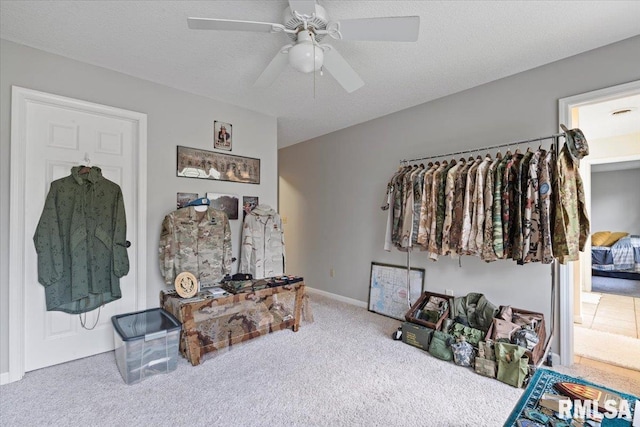 carpeted bedroom with baseboards and a ceiling fan