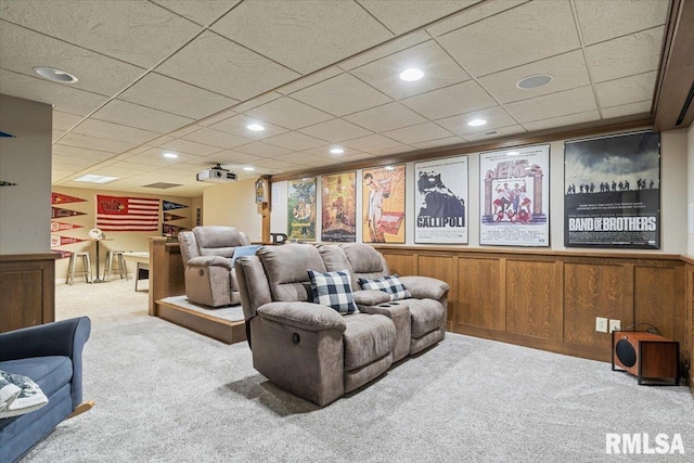 home theater room with recessed lighting, carpet, wooden walls, and a paneled ceiling