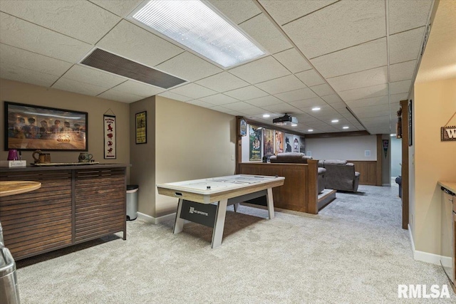 playroom featuring carpet flooring, a drop ceiling, and a bar