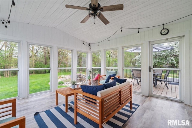 sunroom / solarium with outdoor dining area, a ceiling fan, and outdoor lounge area
