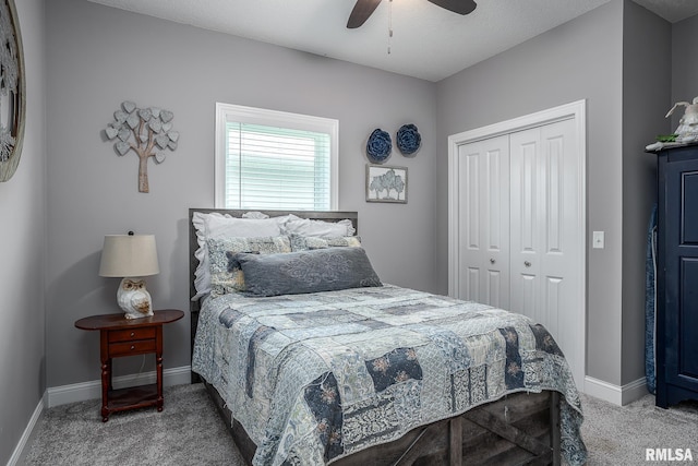 bedroom featuring baseboards, ceiling fan, carpet, and a closet