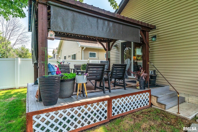 wooden terrace featuring fence and outdoor dining area