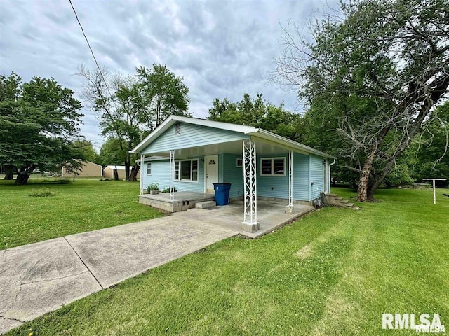 back of house with a yard and a porch
