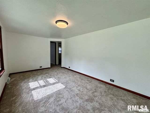 unfurnished room featuring carpet flooring and baseboards