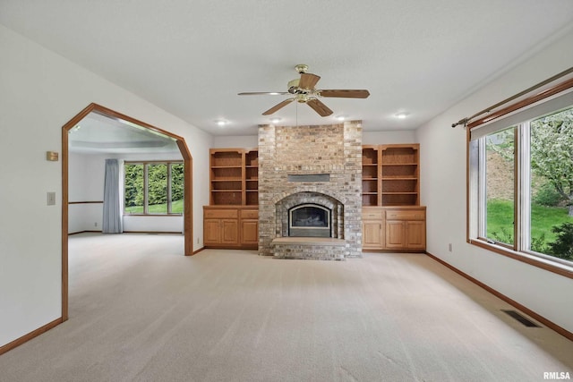 unfurnished living room featuring light colored carpet, baseboards, and visible vents