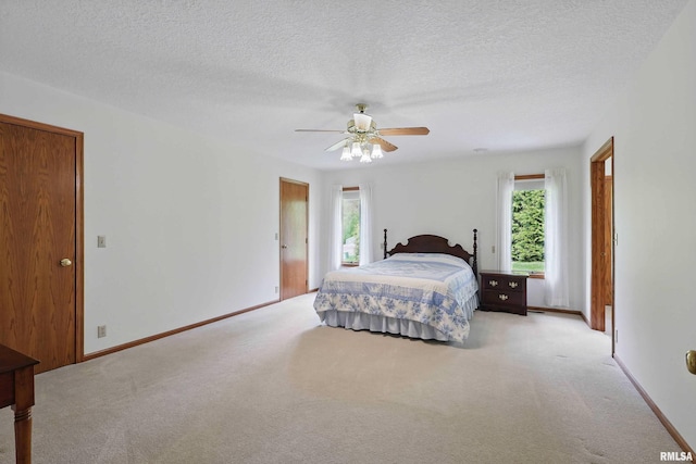bedroom featuring baseboards, carpet flooring, and multiple windows