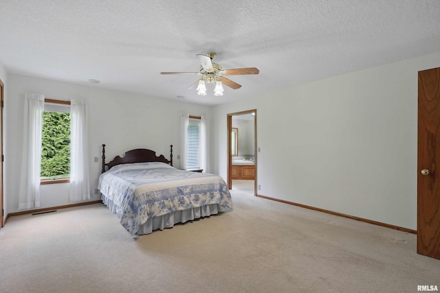 bedroom with ceiling fan, a textured ceiling, visible vents, baseboards, and light carpet