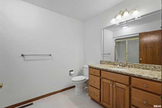 full bath with visible vents, vanity, toilet, baseboards, and a shower with shower door