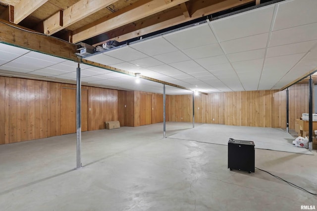 finished below grade area featuring wooden walls