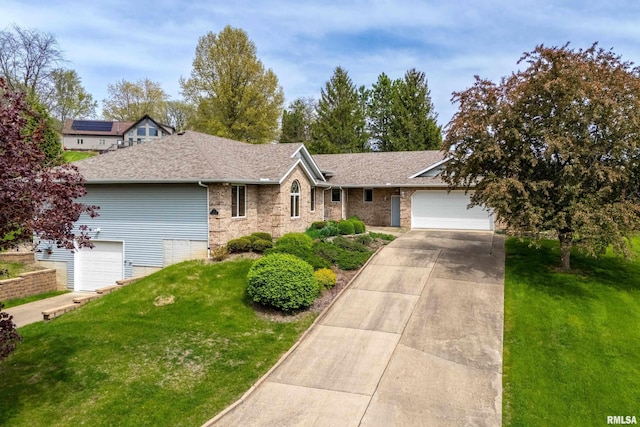 single story home with roof with shingles, concrete driveway, brick siding, and a front yard