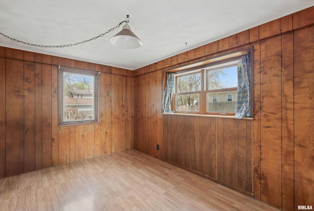 unfurnished room with wood walls and wood finished floors