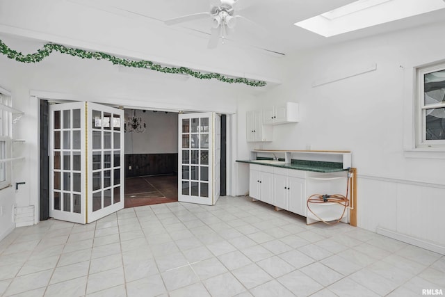 interior space with a ceiling fan and a sink
