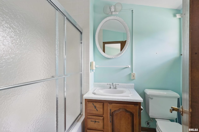 full bath featuring vanity, an enclosed shower, and toilet