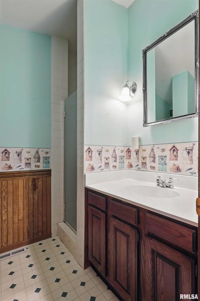 full bathroom featuring vanity, an enclosed shower, tile patterned floors, and visible vents