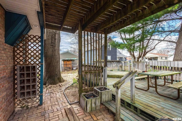 wooden terrace with outdoor dining area and fence