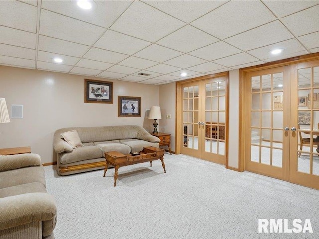 living room featuring a paneled ceiling, recessed lighting, carpet floors, and french doors