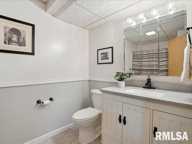 full bath featuring tile patterned flooring, vanity, toilet, baseboards, and a shower with curtain