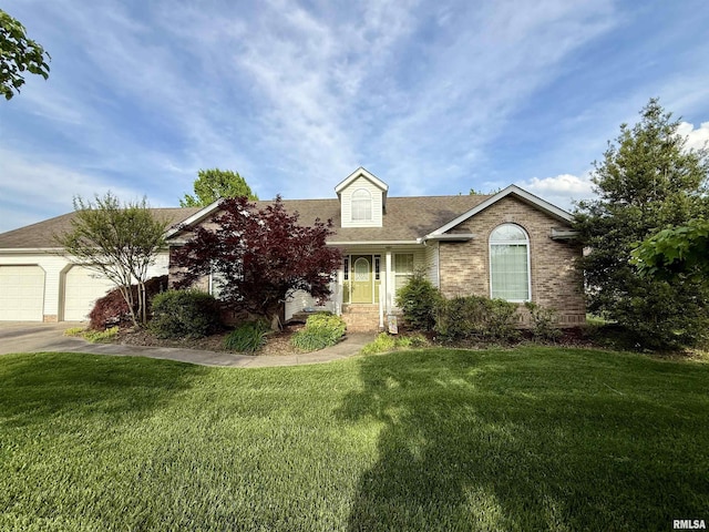 106 Jeremy Dr, Carterville, IL 62918 - view of front facade with a shingled roof, a front lawn, brick siding, a garage, and driveway