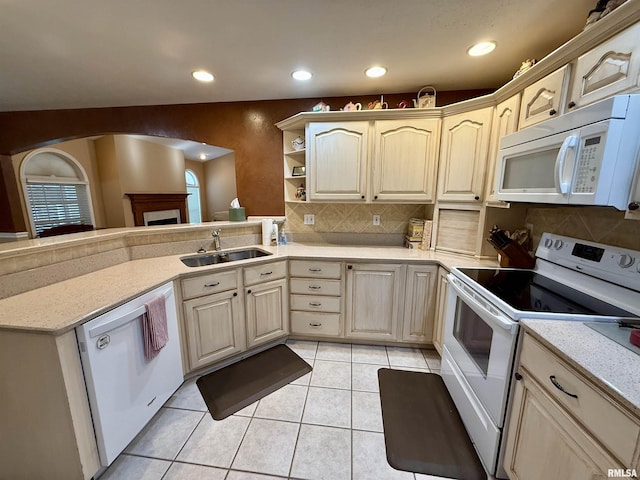 106 Jeremy Dr, Carterville, IL 62918 - kitchen featuring tasteful backsplash, a sink, light tile patterned floors, a peninsula, and white appliances