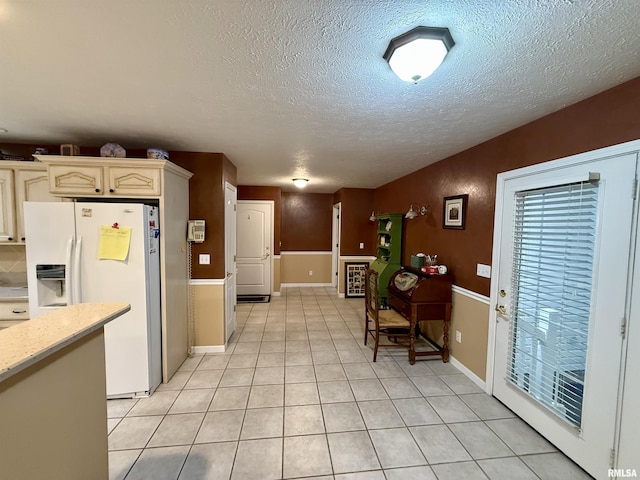 106 Jeremy Dr, Carterville, IL 62918 - kitchen featuring white fridge with ice dispenser, light tile patterned flooring, and a textured ceiling